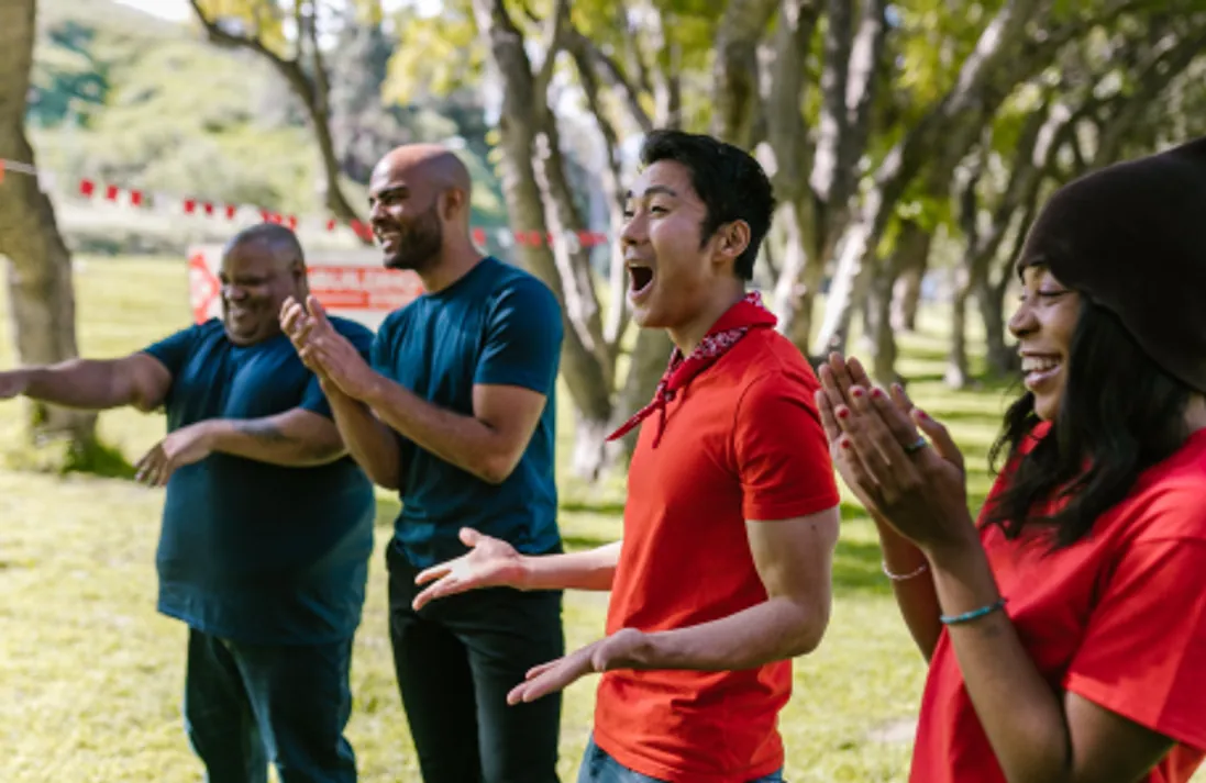 Members of the association applauding outdoors